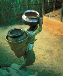 Photograph by Kevin Kelly, woman carrying water containers