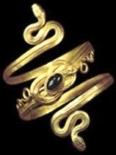Gold spiral bracelet of two snakes whose tails are tied in a Hercules knot that is decorated with a garnet in a bezel setting; from Eretria, on the island of Euboea, 4th–3rd century BC