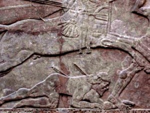 Wall carving from the northwest palace at Nimrud: a soldier in battle struck a mortal wound by an arrow; he is trampled underfoot by a chariot horse
