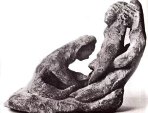 Ancient statuette of two midwives helping a woman giving birth