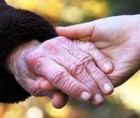 Joined hands of an older and a younger woman