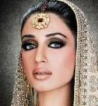 Beautiful woman with lavish jewellery and richly embroidered head veil