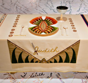 Judy Chicago, The Dinner Party: the place setting for 'Judith'. Note the vulva-shaped plate and the sword that forms part of Judith's name.