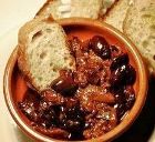 Bread and olives with a lamb stew