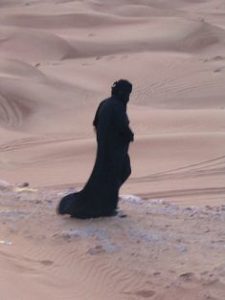 Middle Eastern woman alone in the desert
