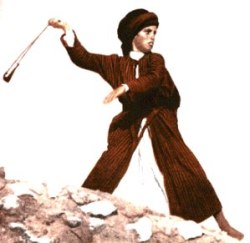A young boy using a sling shot