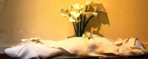 Body in a shroud, with lilies