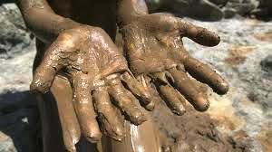 Hands covered in mud