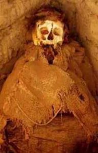 A Peruvian mummy in an open grave