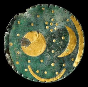 The Nebra disk, constructed about 3,600 years ago. It shows a sun or full moon, a lunar crescent, 