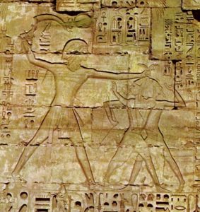 Rameses III kills his enemies with a sickle sword, Medinet Habu, 20th dynasty