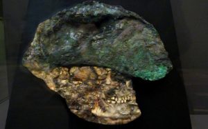 Flattened copper helmet and skull found in the Royal Tomb at Ur
